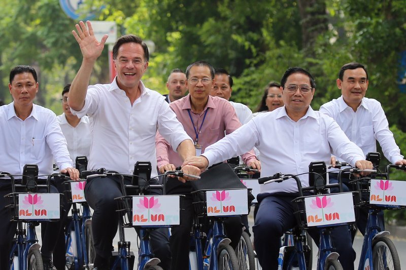 Vijetnamski premijer Pham Minh Chinh (desno) i njegov nizozemski kolega Mark Rutte (lijevo) voze bicikle na ulici vijetnamskog grada Hanoja.