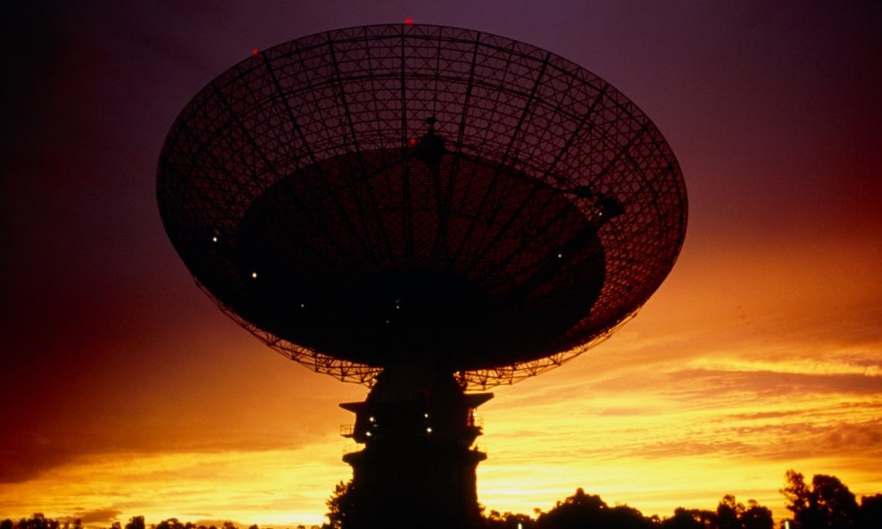 Parkes radio telescope. View of Parkes radio telescope, New South Wales, Australia at sunset. The rotating dish is 64 metres in diameter and divided into three sections. It has a solid steel plate from its centre to a diameter of 17 metres, a perforated a