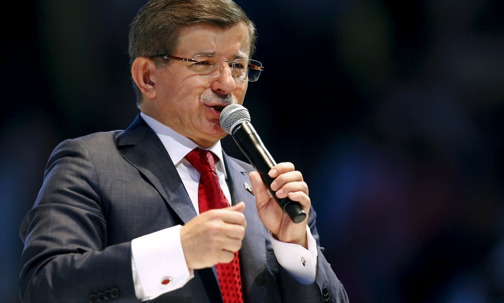 Turkish Prime Minister Ahmet Davutoglu addresses the 5th Congress of AK Party (AKP) in Ankara, Turkey, September 12, 2015. As Turkey's ruling AK Party convened its congress in the capital Ankara on Saturday, the longest shadow was cast by a politician who