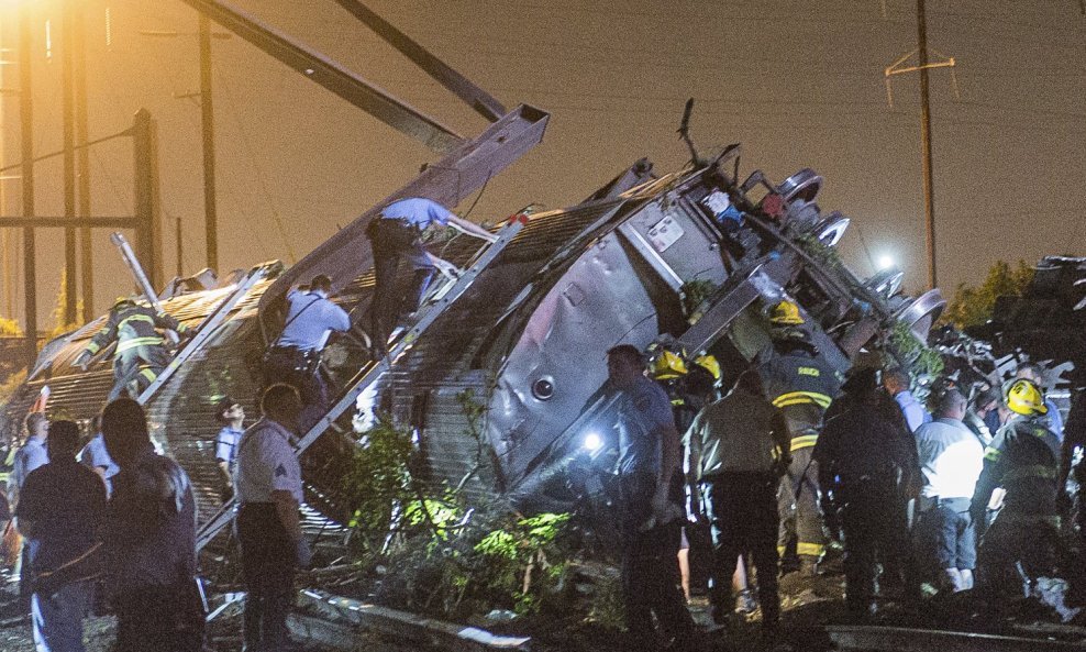 Rescue workers search for victims in the wreckage of a derailed Amtrak train in Philadelphia, Pennsylvania May 12, 2015. An Amtrak passenger train with more than 200 passengers on board derailed in north Philadelphia on Tuesday night, killing at least fiv