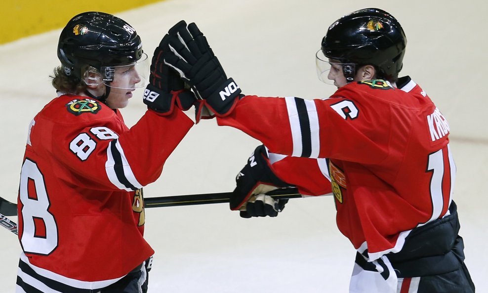 Patrick Kane (L) celebrates his goal with teammate Marcus Kruger